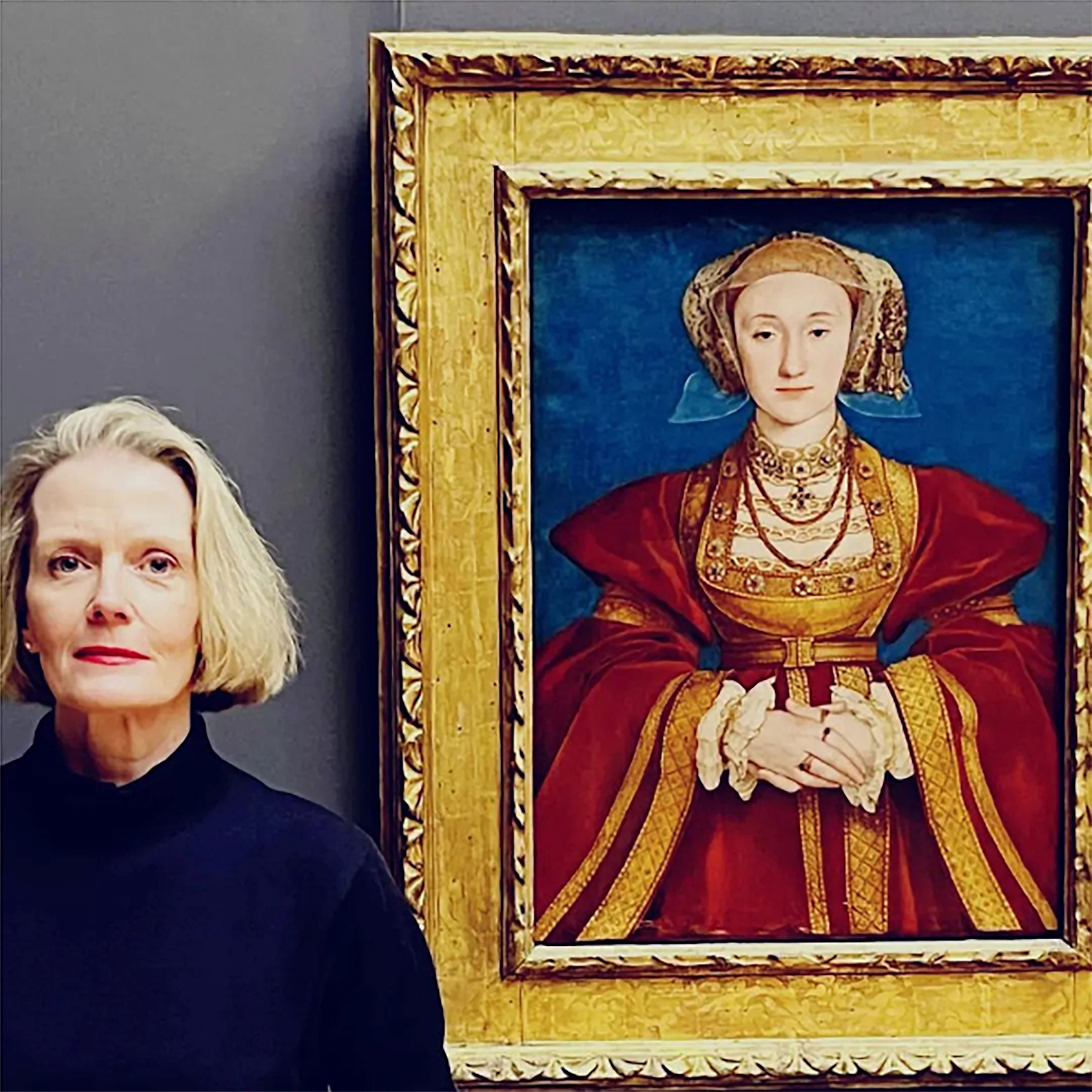 Photograph of Wendy standing beside a painting by Hans Holbein